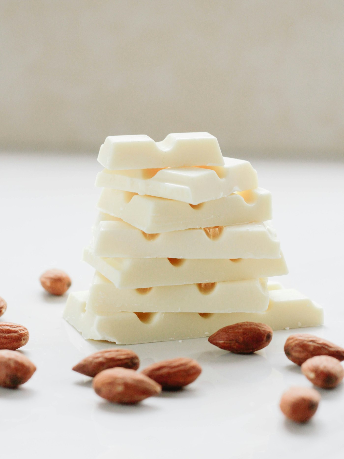 Stacked white chocolate bars decorated with freeze-dried berries and rose petals