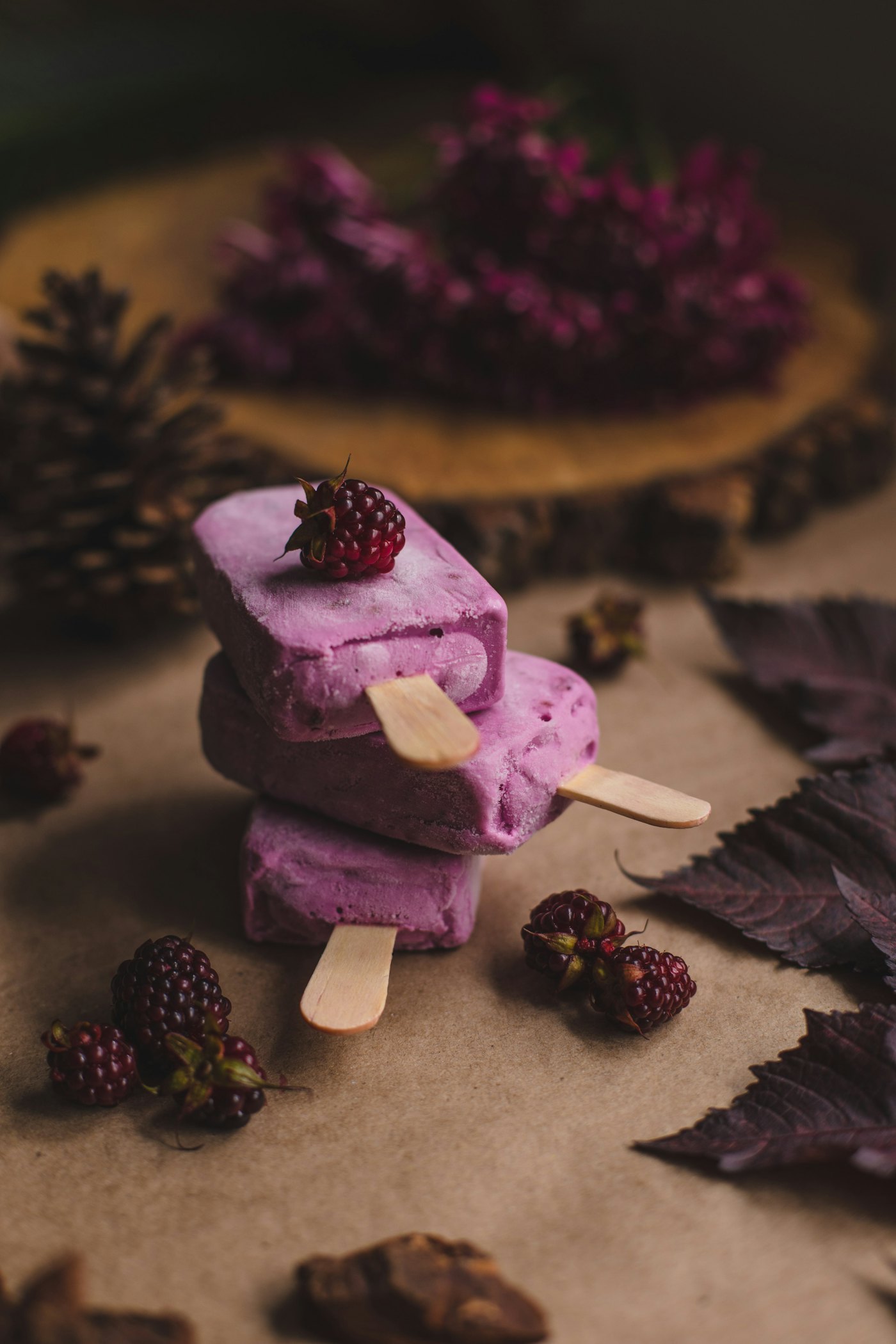 Deep-purple blackberry popsicles with seeds suspended throughout the ice