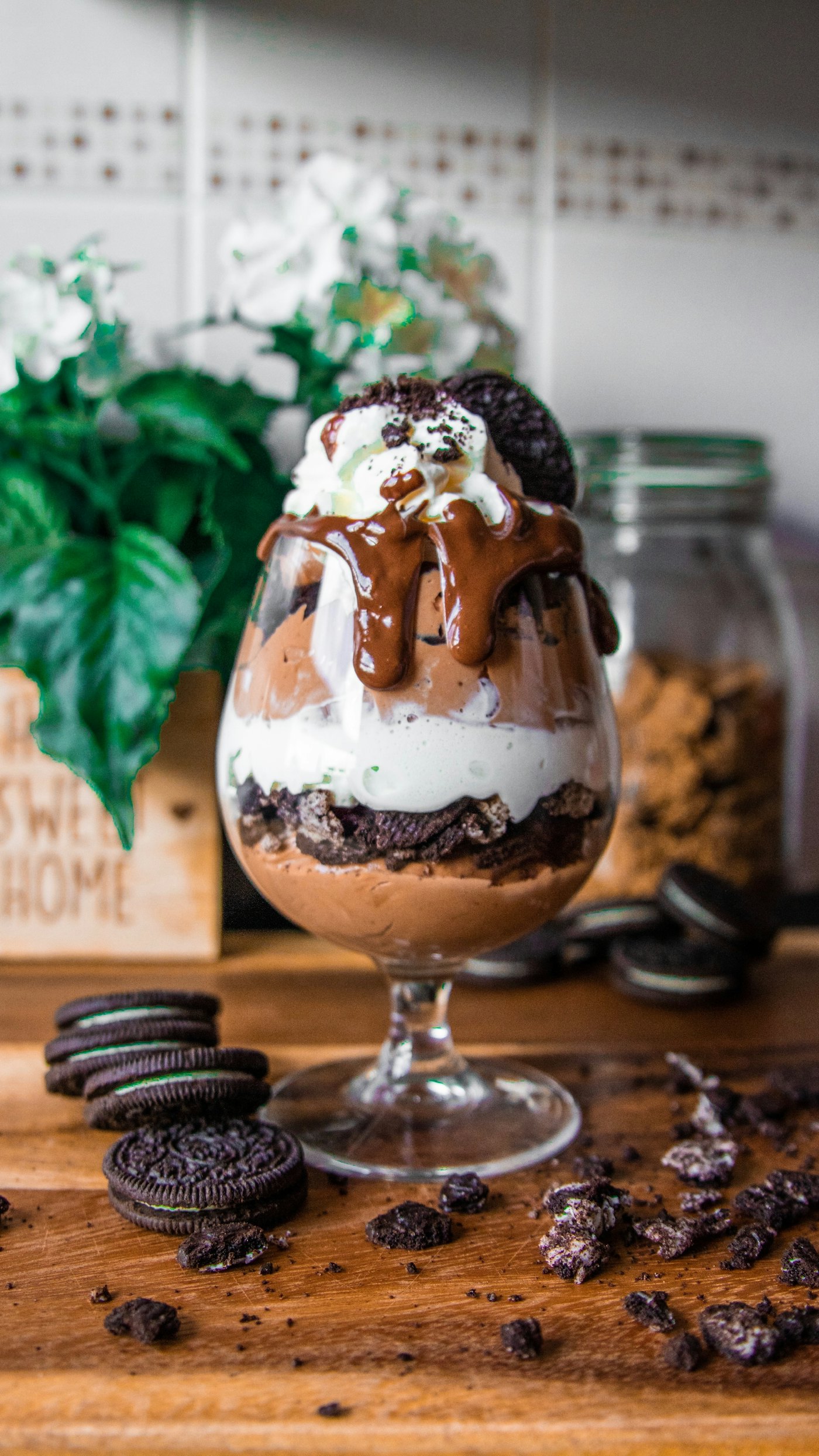 A triple-chocolate sundae served in a tall glass