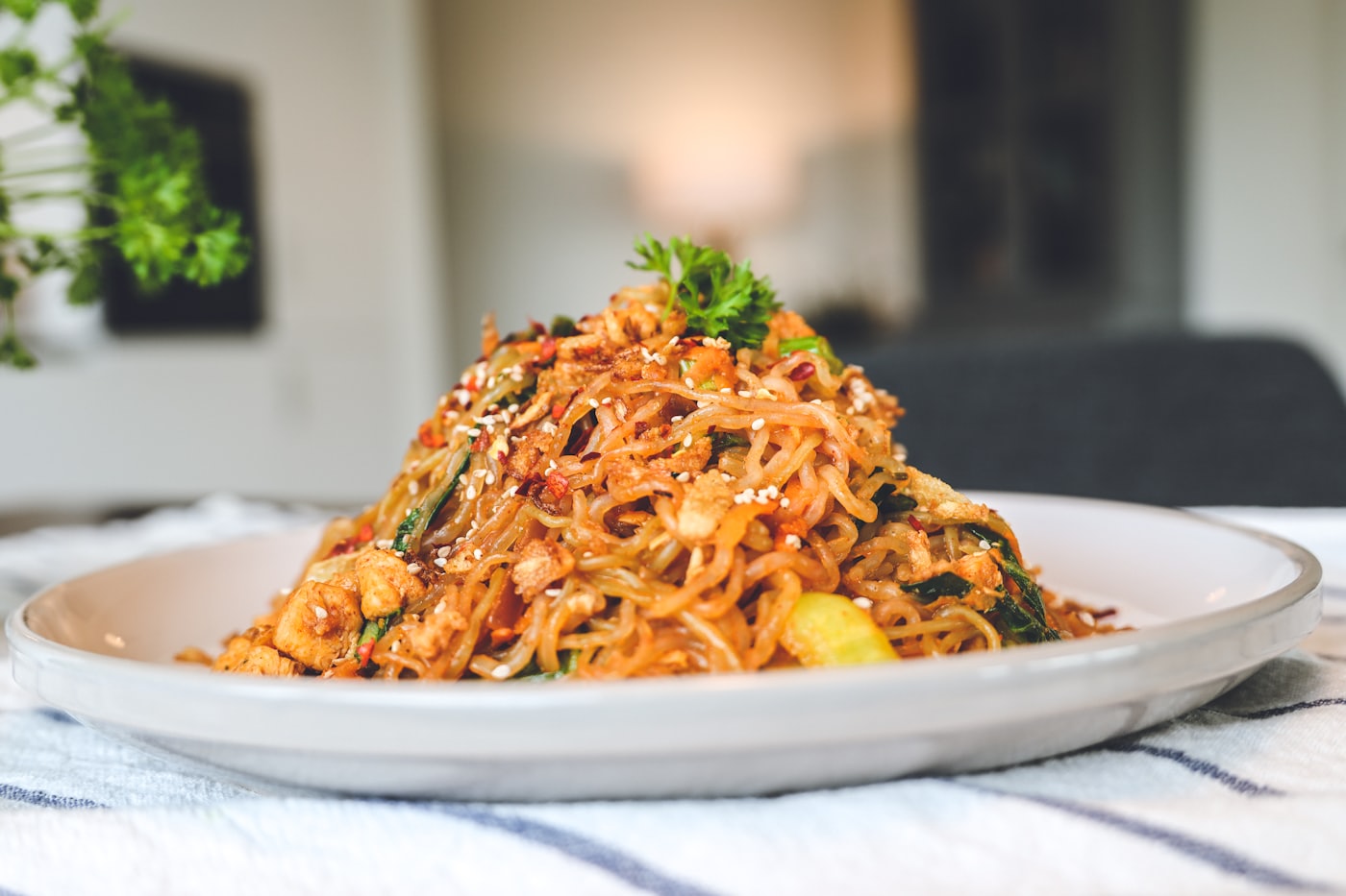 A plate of fried mee goreng noodles with chilli and egg