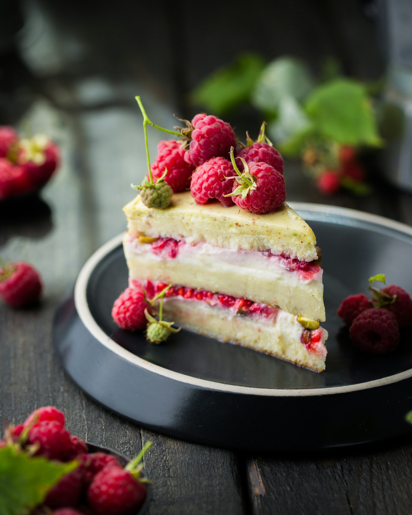 A generous slice of red velvet cake with cream cheese frosting on a white plate