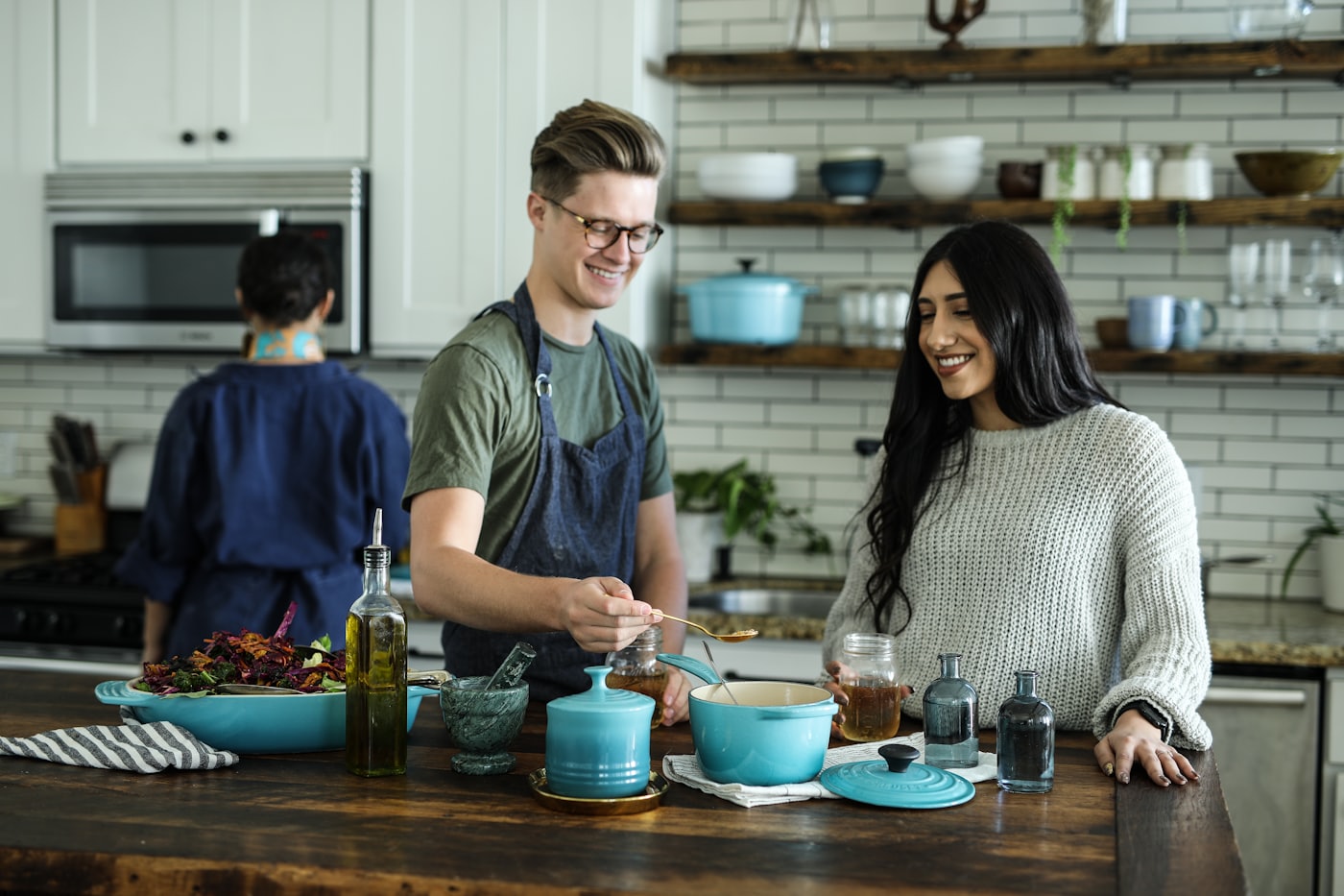Two Tattva chefs plating desserts together in the kitchen